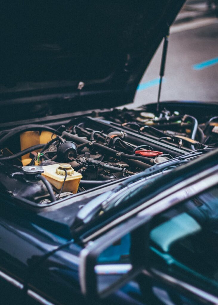 Detailed view of an exposed car engine under maintenance in Barcelona.