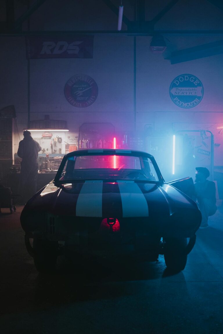 A classic car in a neon-lit garage, exuding a cool automotive vibe.